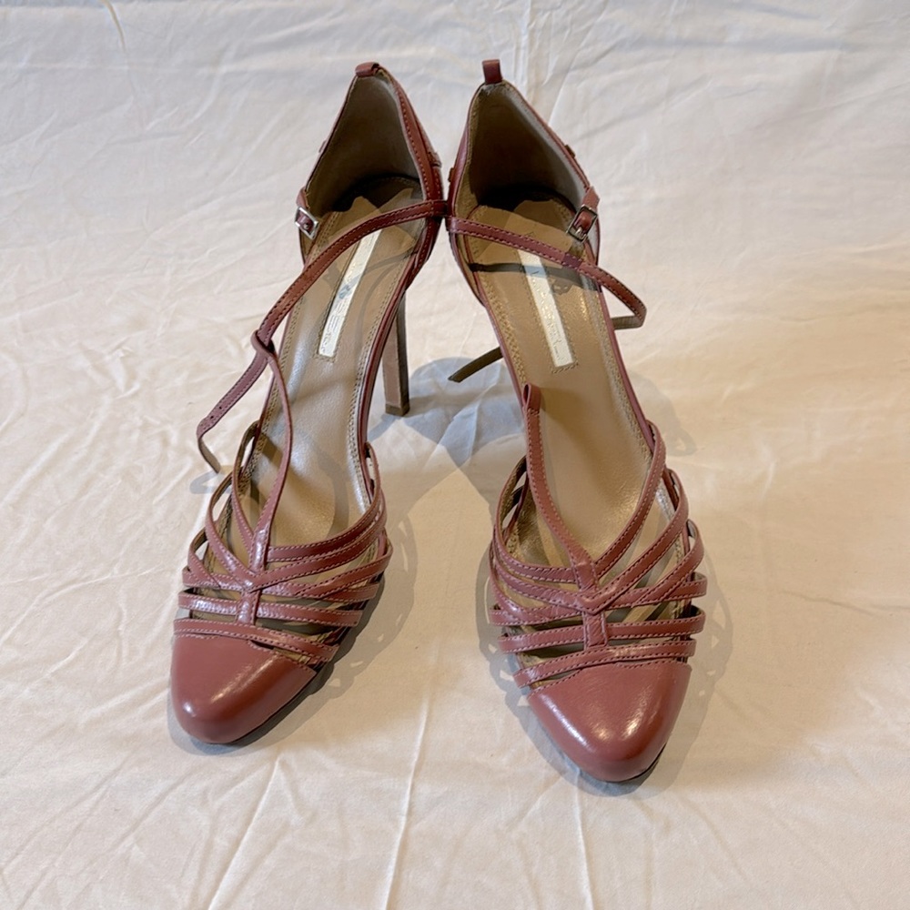 Pink closed toe caged heels.